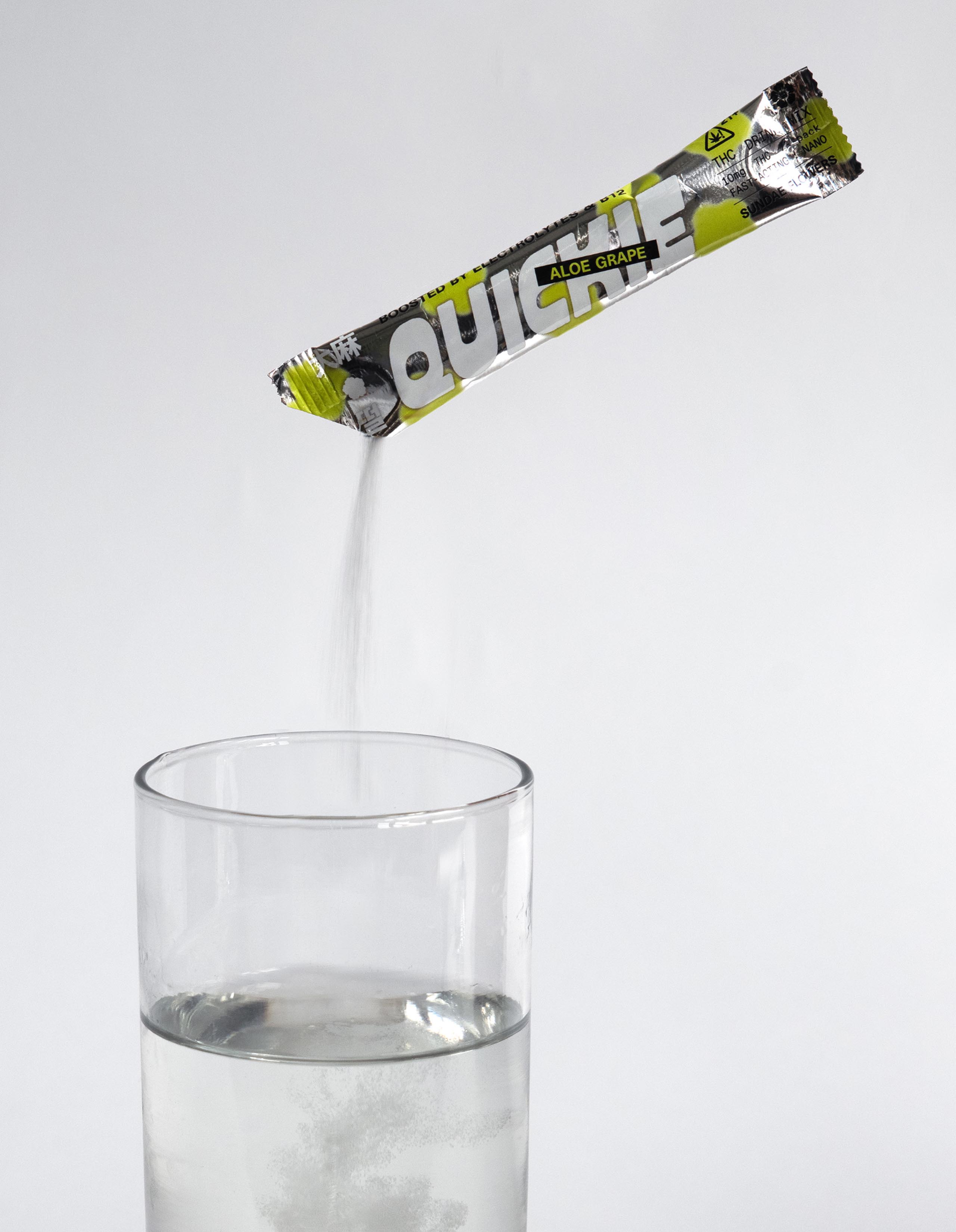 Aloe grape quickie being poured into a glass of water.