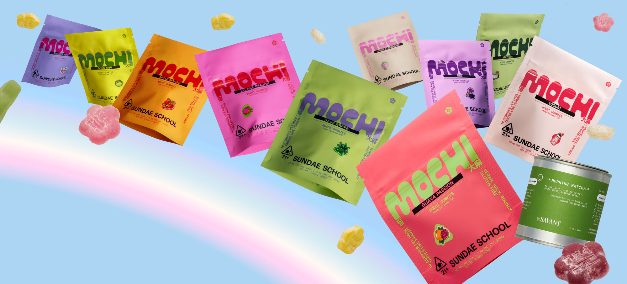 Colorful Sundae School "Mochi Gummies" pouches float against a light blue background with a soft rainbow. A pink "Yogurt" pack, coral "Guava Passion" pack, and a green "Morning Matcha" candle tin sit in the foreground, surrounded by loose gummy candies and other vibrant flavor pouches.