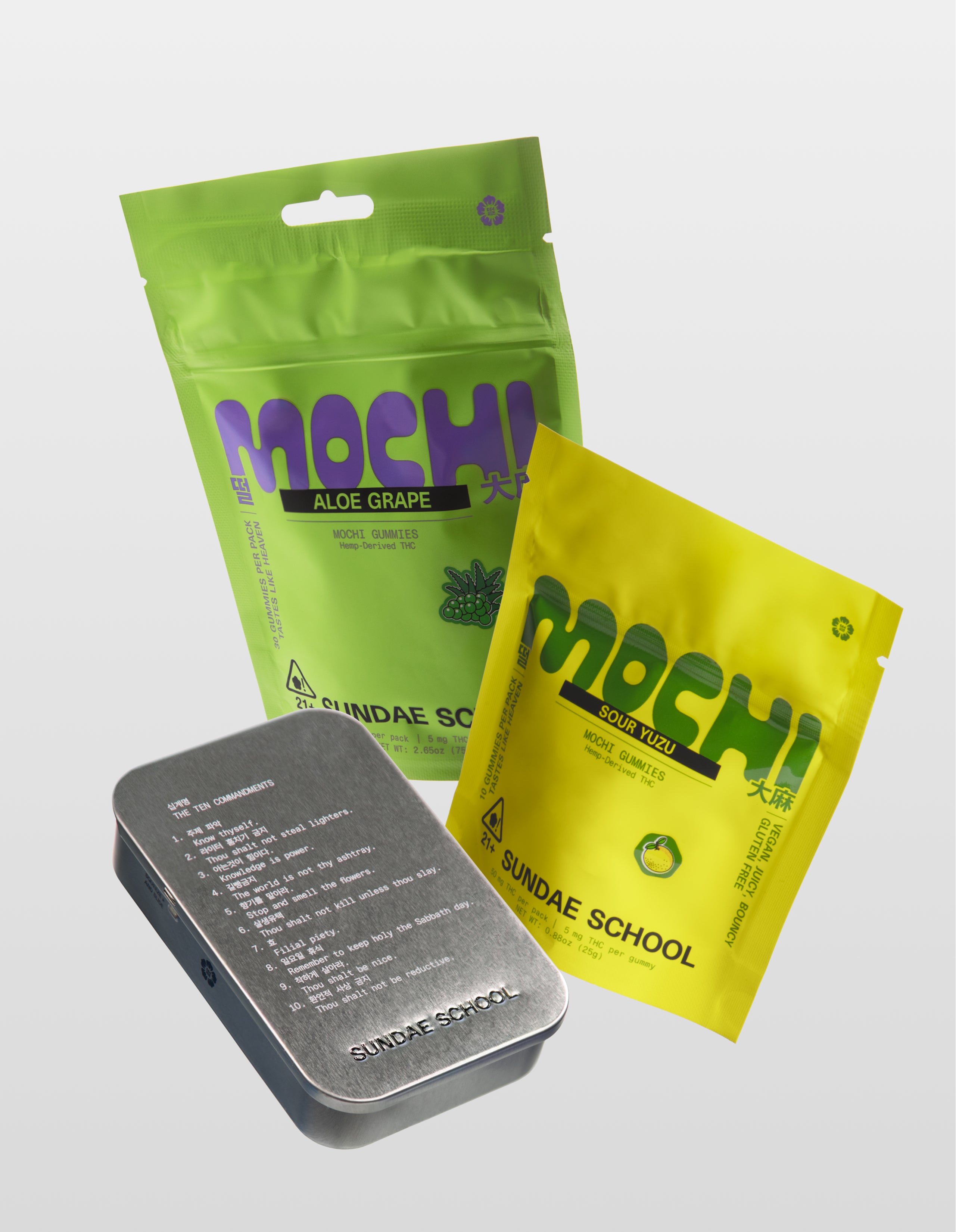 Sundae School mochi gummies CA Sober product bundle featuring Aloe Grape 30-Pack, Sour Yuzu 10-pack, and silver metal tin container on white background