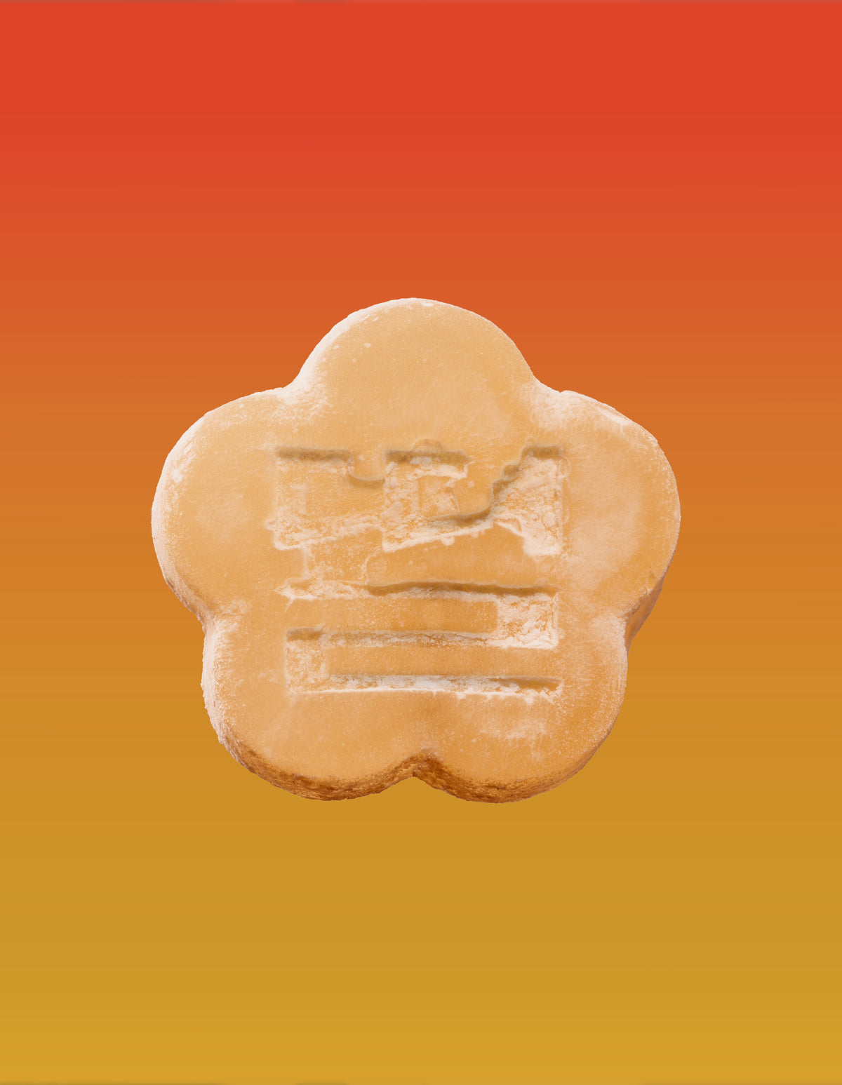 An image of an apple mango gummy on a gradient background going orange to yellow.