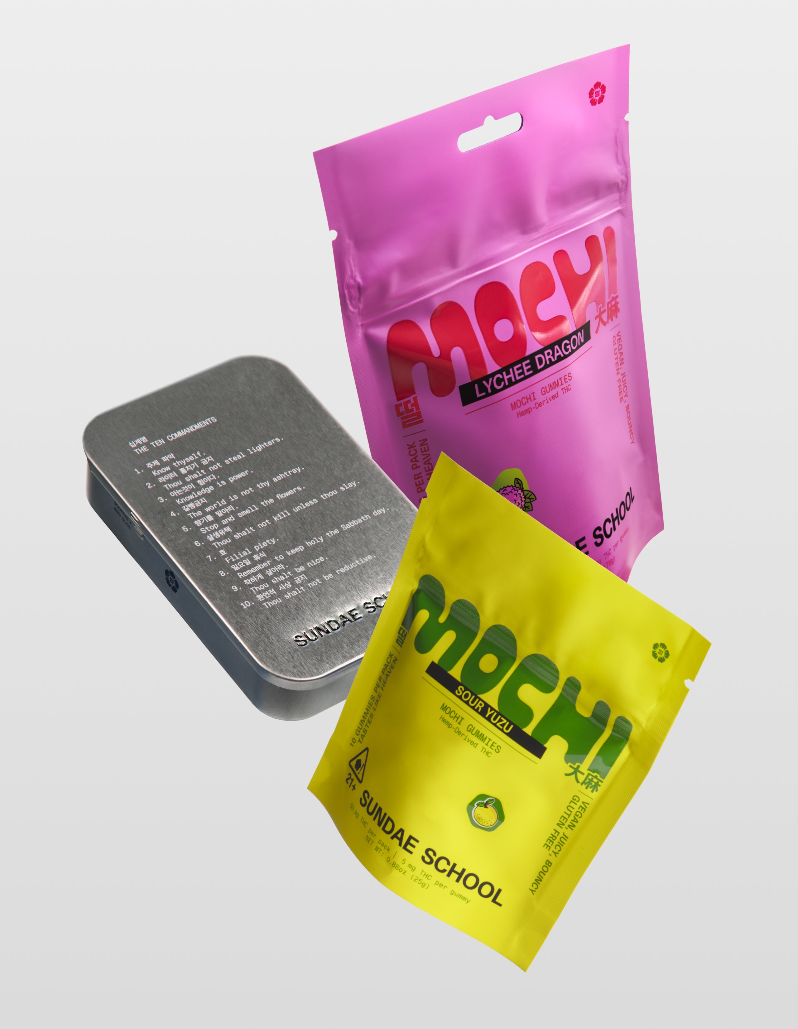 Sundae School mochi gummies Euphoria product bundle featuring a Lychee Dragon 30-Pack, Sour Yuzu 10-pack, and silver metal tin container on white background