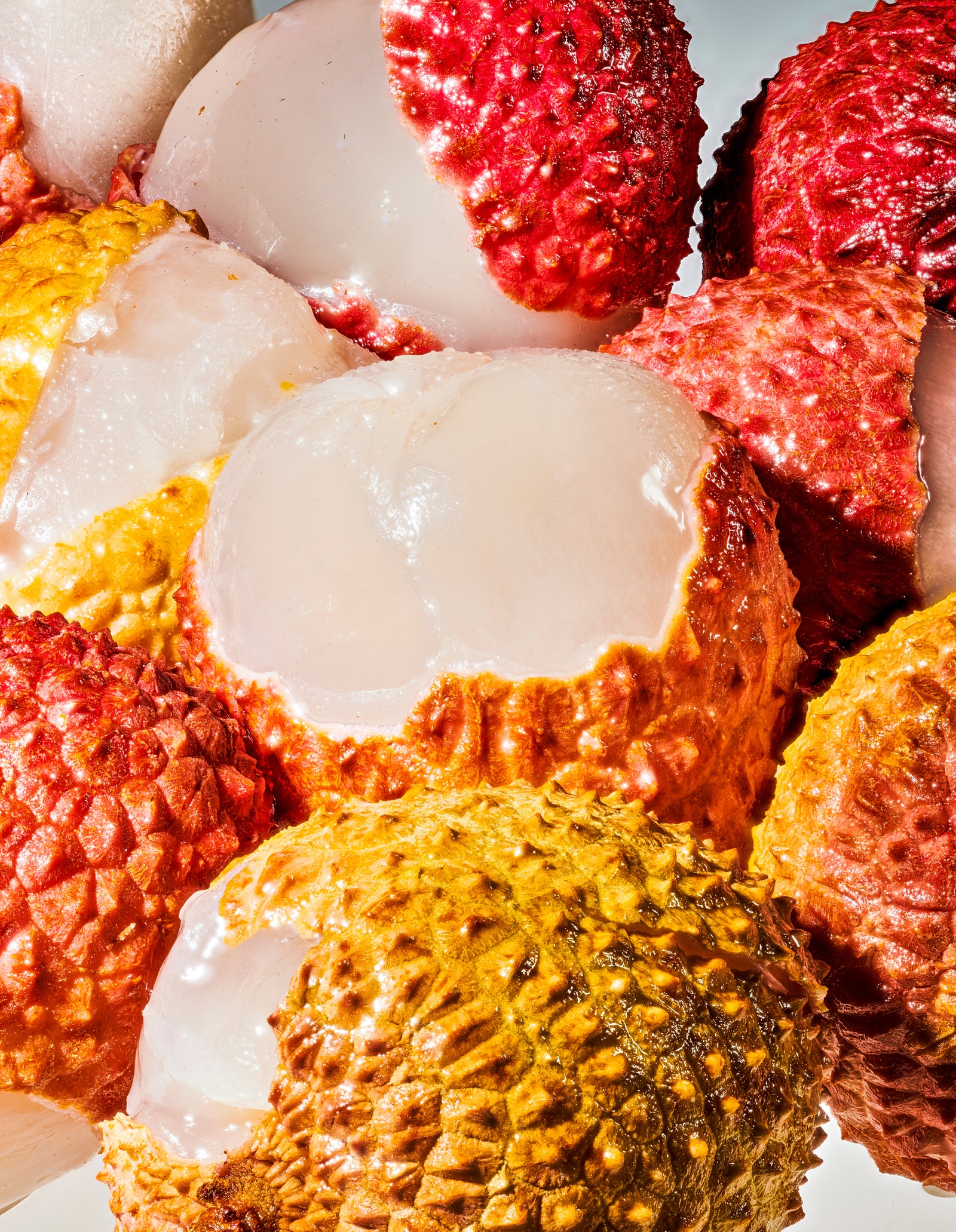 A close-up image of a bunch of semi-peeled lychee. 
