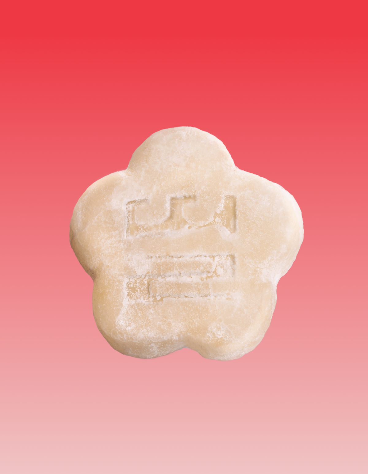 One yellowish white mochi gummy against a red gradient background.