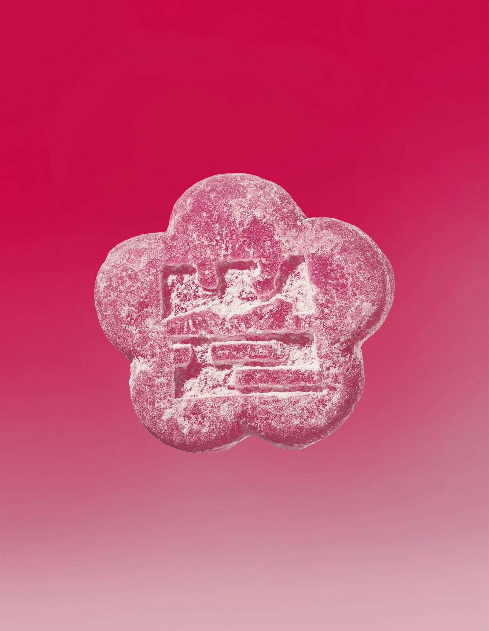 An image of a lychee dragon gummy on a gradient background going pink to light pink.