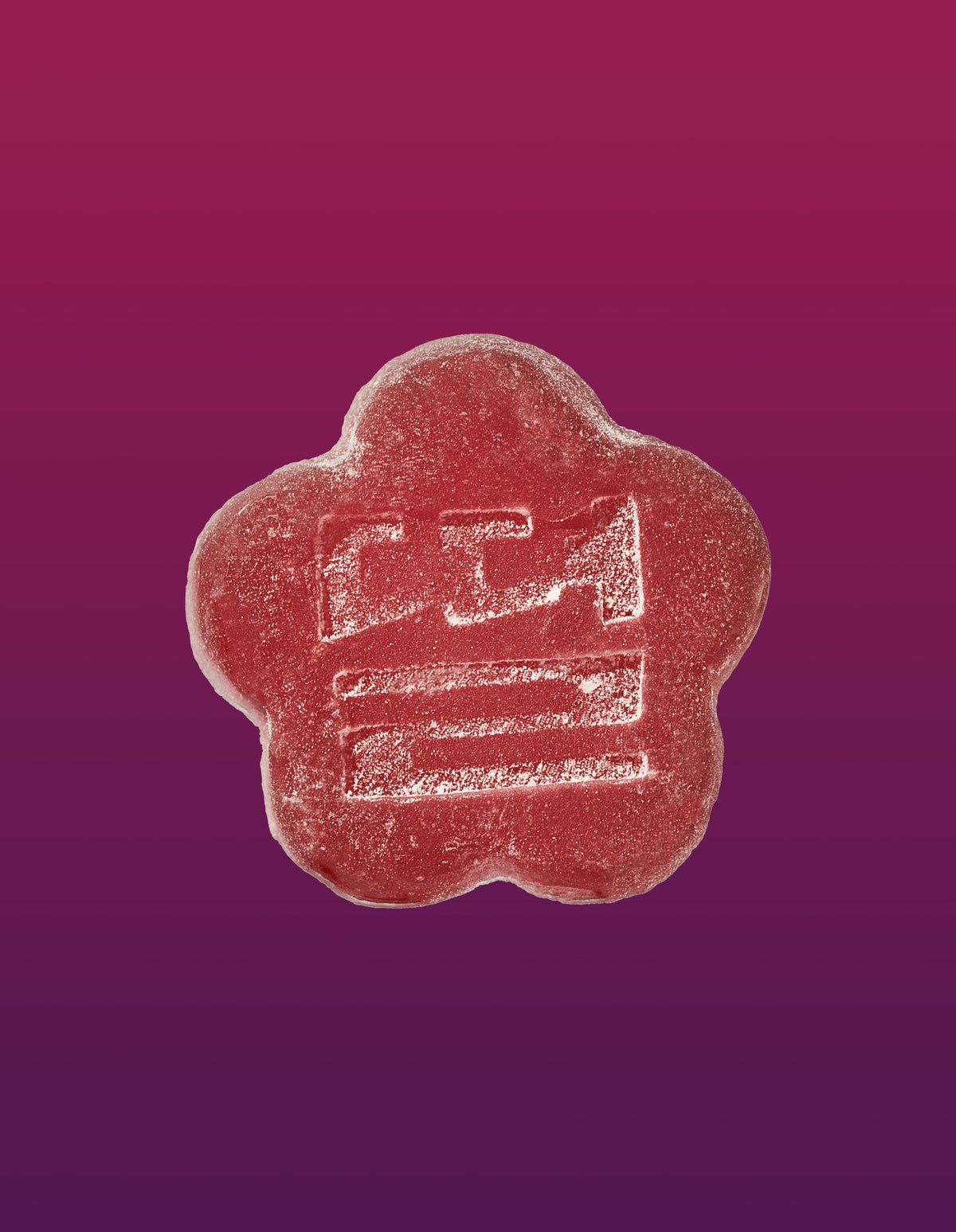 An image of a Slumber Berry gummy on a gradient background going pink to purple.