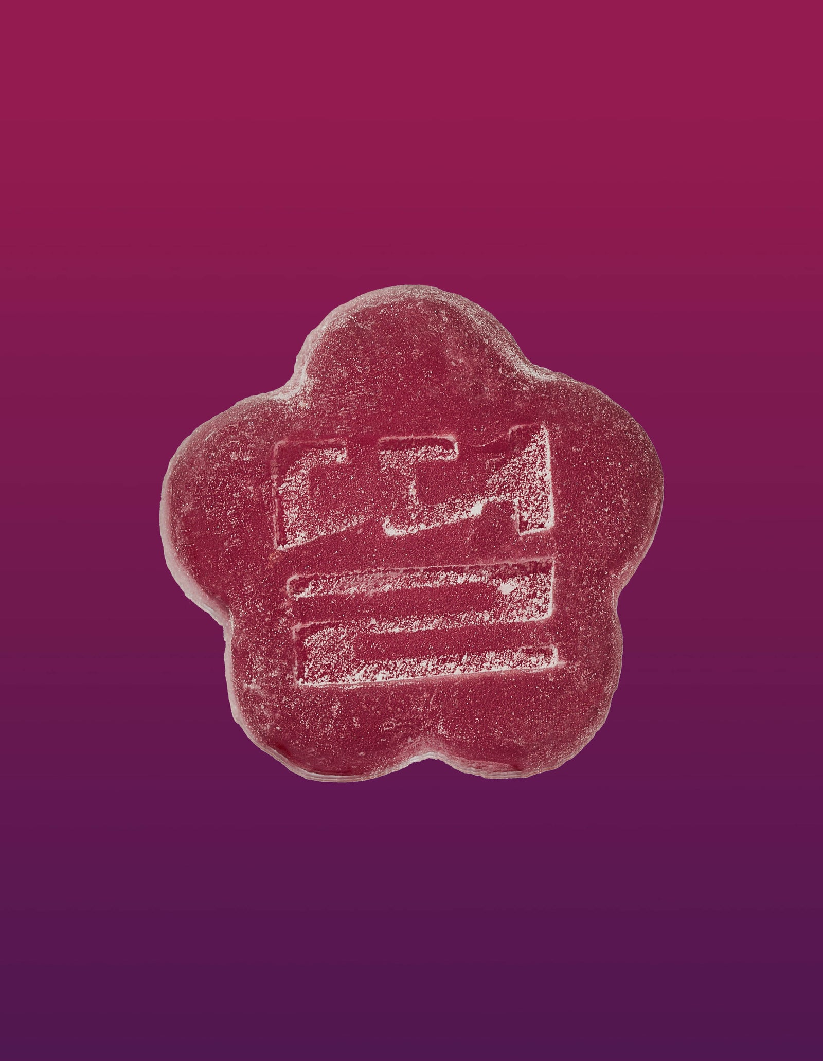 An image of a slumber berry gummy on a gradient background going pink to purple. 