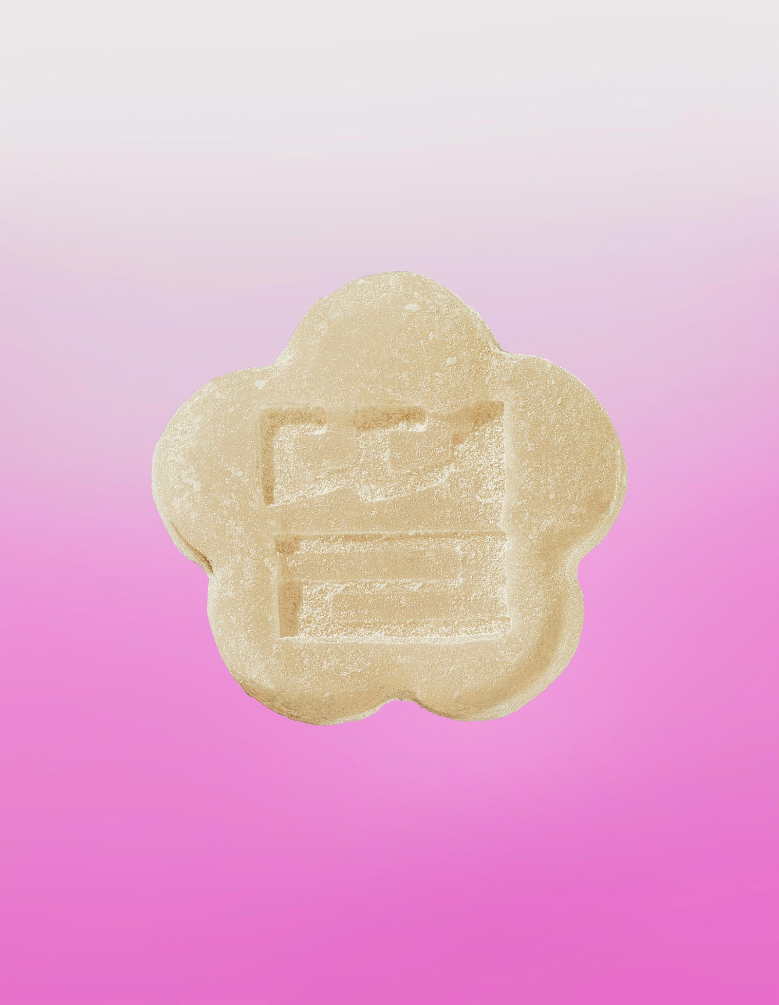 Image of a white strawberry mochi gummy on a gradient background going white to pink.