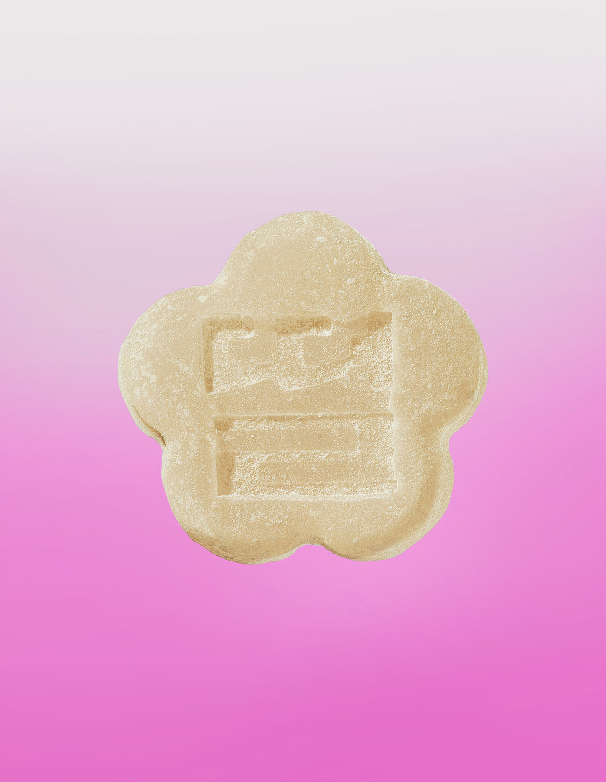 An image of a white strawberry gummy on a gradient background going white to pink.
