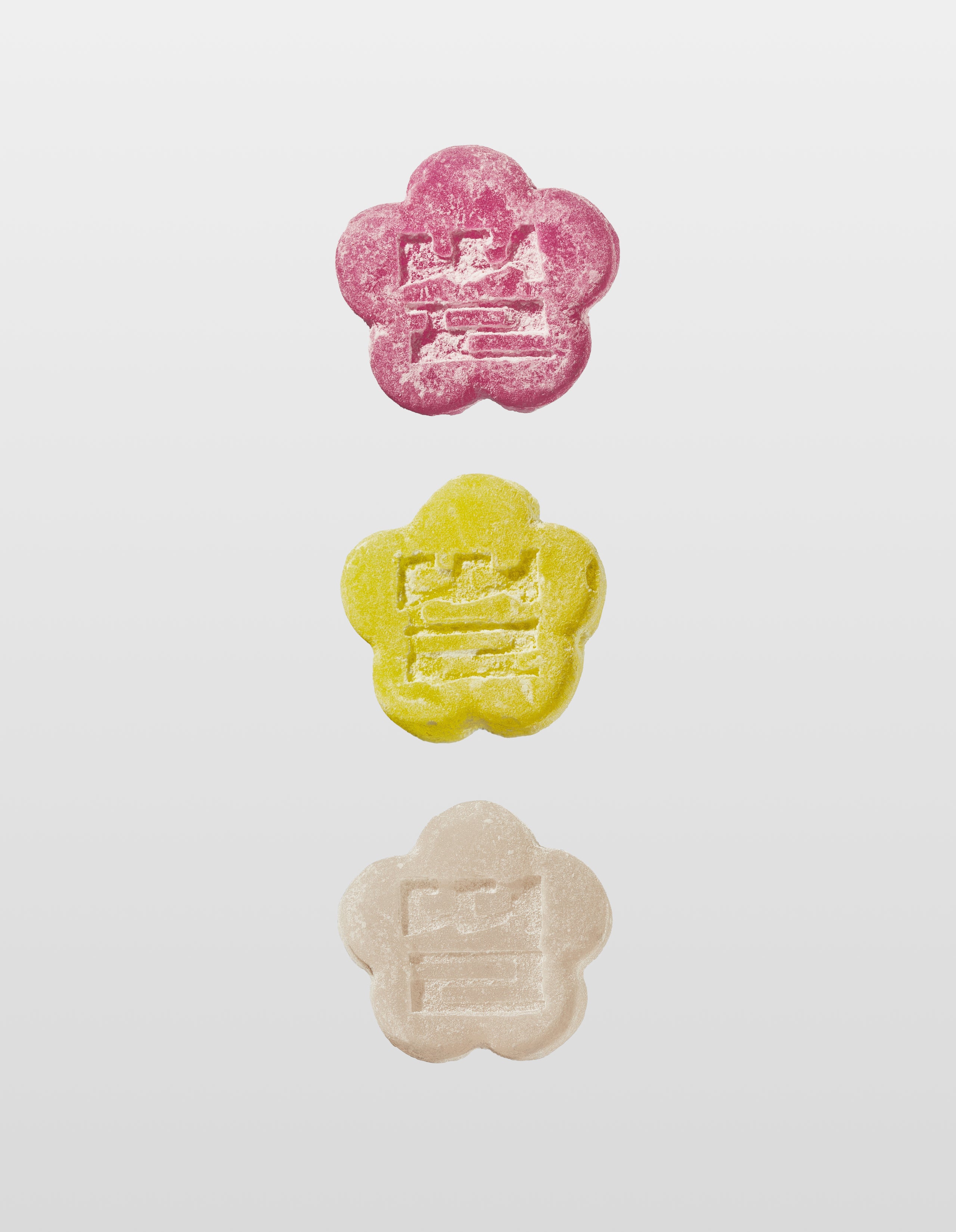 Sundae School Lychee dragon mochi gummy, Sour yuzu mochi gummy, White strawberry mochi gummy laid against a white background