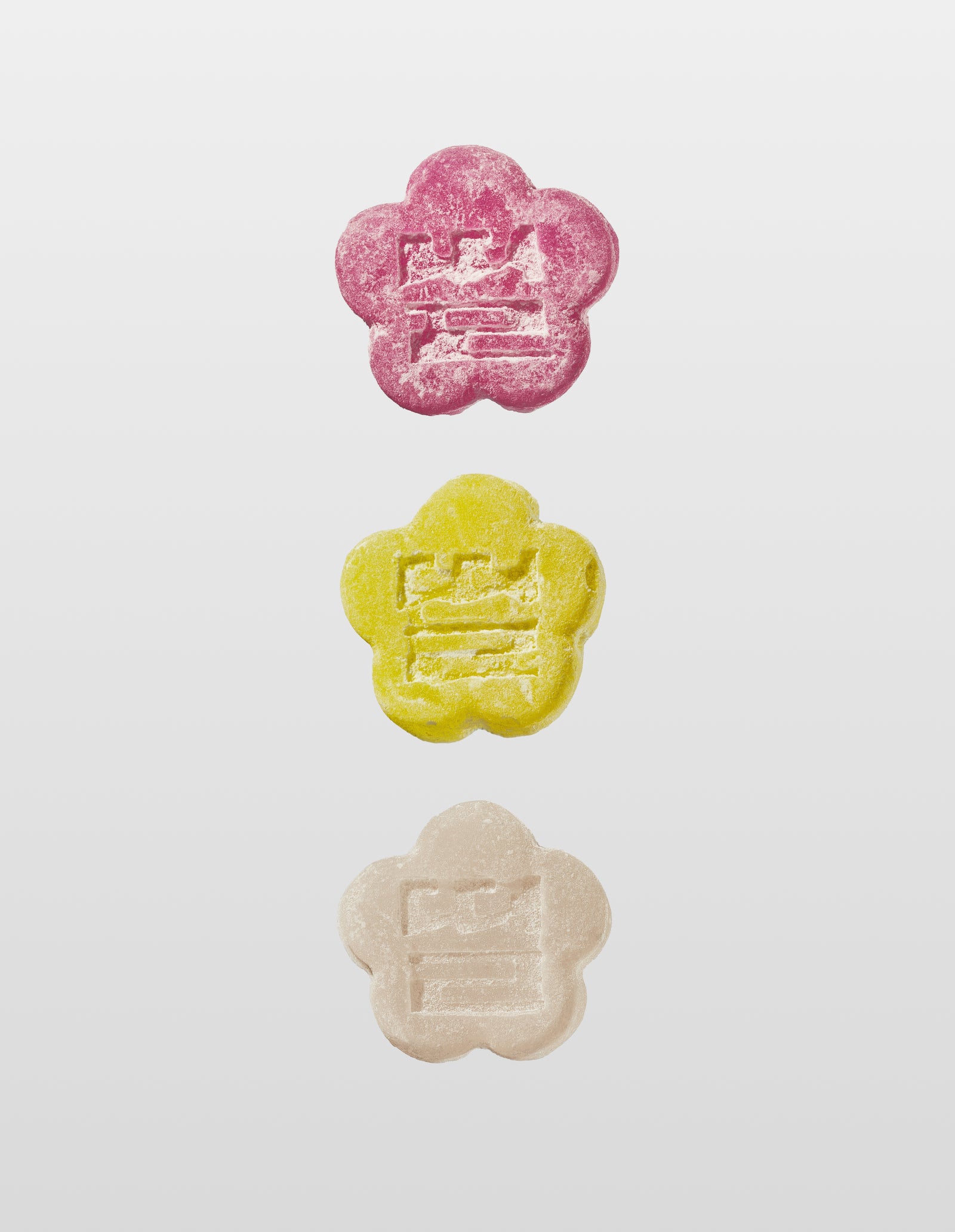 Sundae School Lychee dragon mochi gummy, Sour yuzu mochi gummy, White strawberry mochi gummy laid against a white background