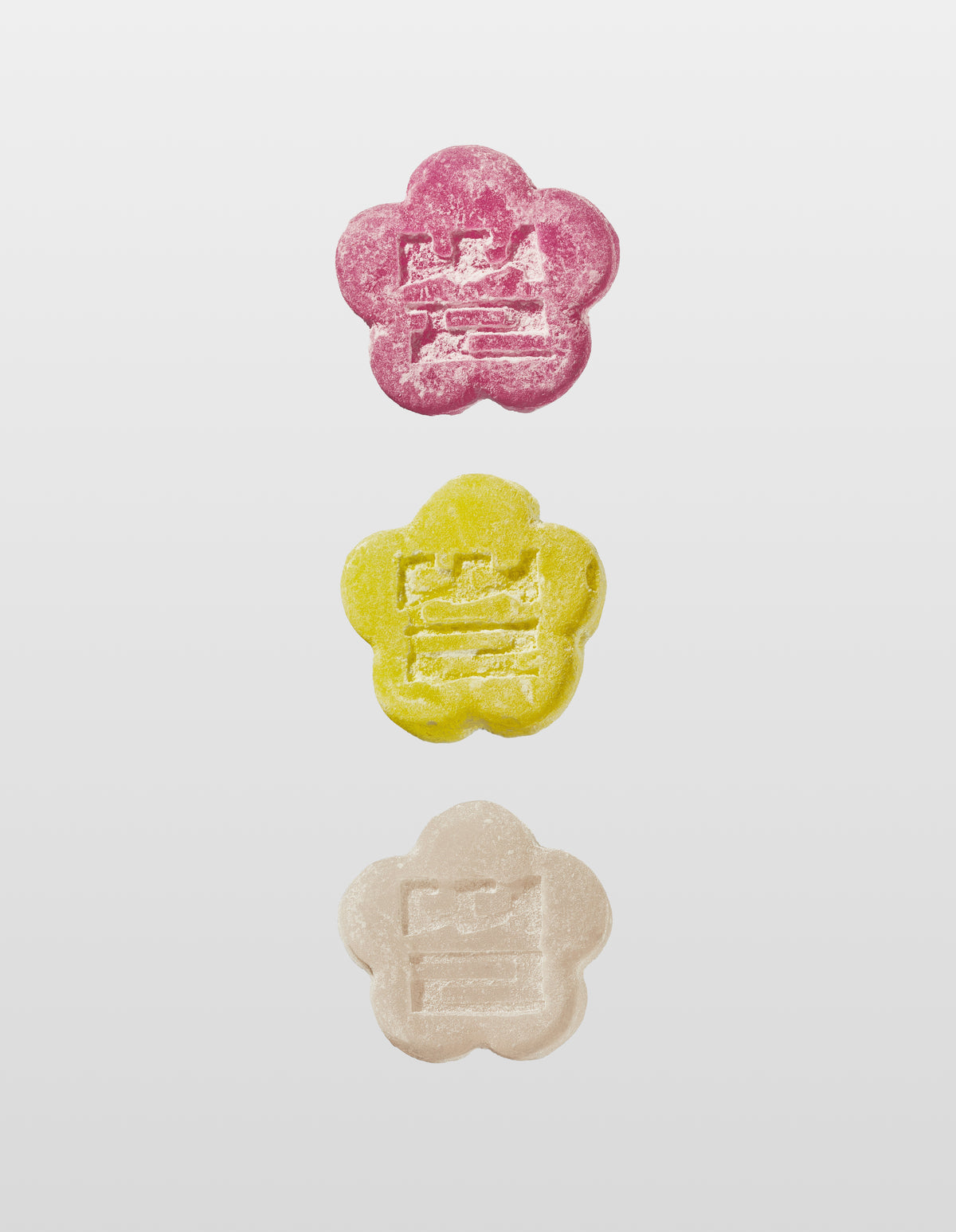 Sundae School Lychee dragon mochi gummy, Sour yuzu mochi gummy, White strawberry mochi gummy laid against a white background