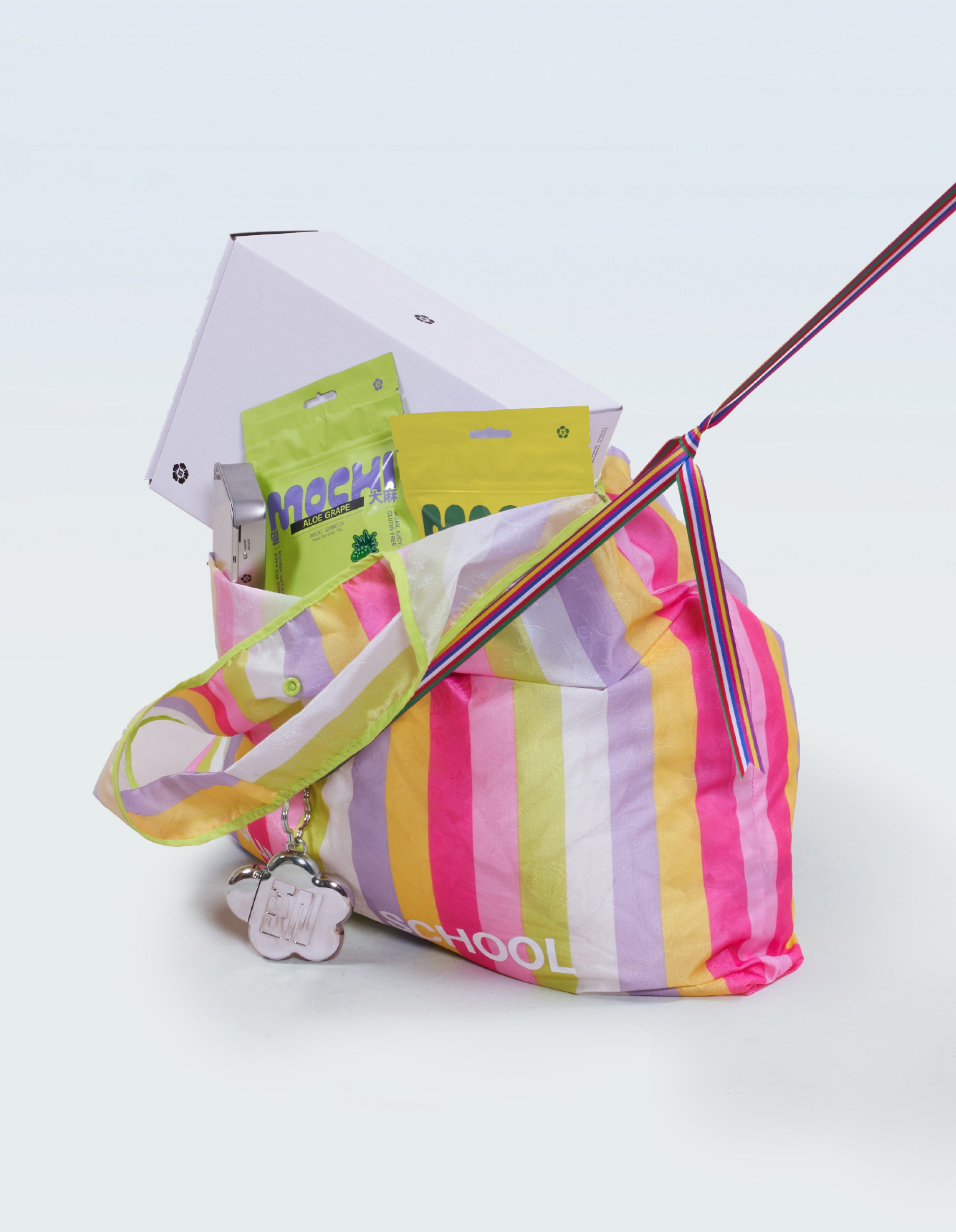 An image of Sundae School mochi tin, 30ct Aloe grape mochi gummy, 30 ct Sour Yuzu mochi gummy, and Sundae School gift box packaged in Sundae School big bojagi bag. 