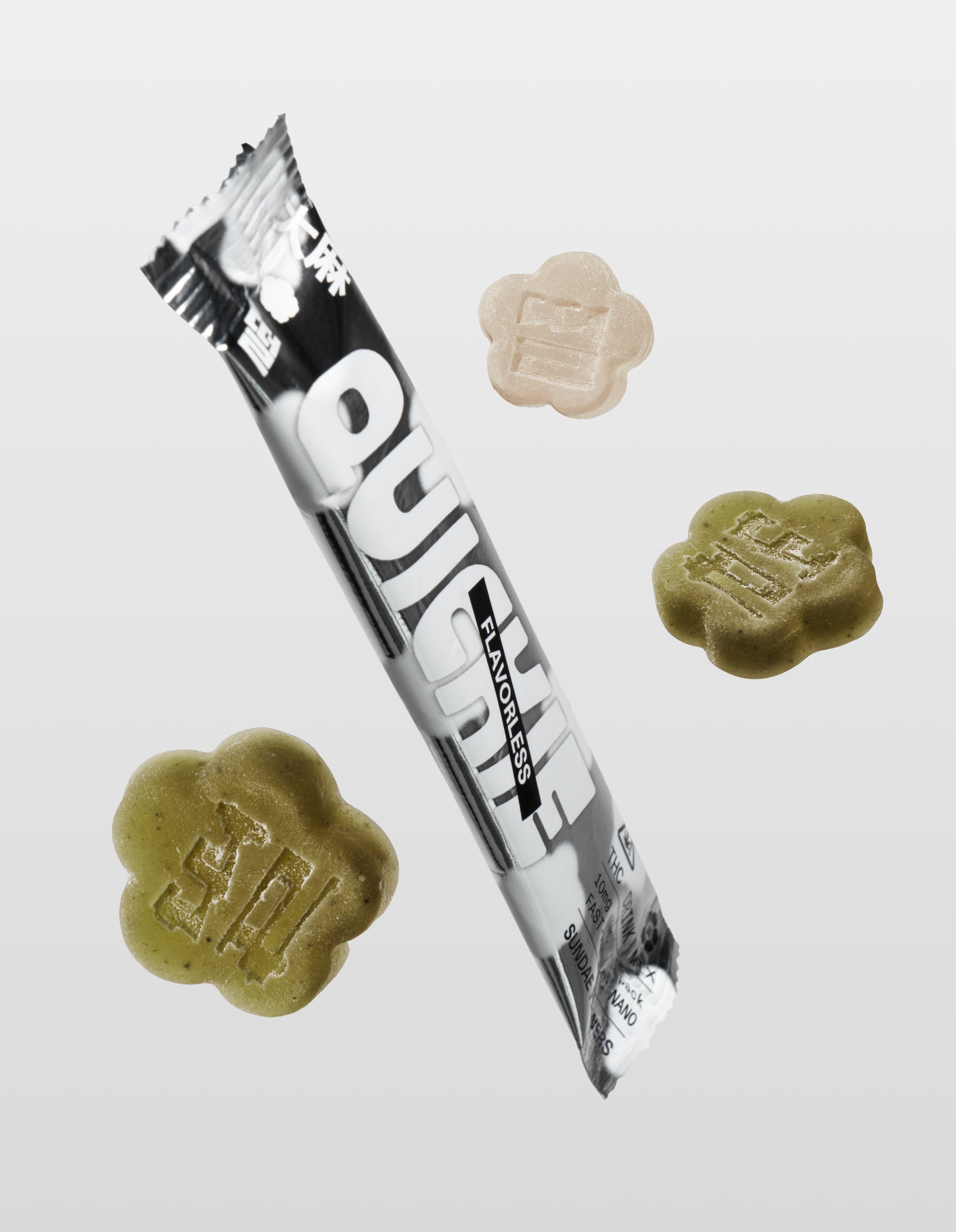 Sundae School Flavorless Quickie stick, two matcha mochi gummies, and one white strawberry mochi gummy against a white background.