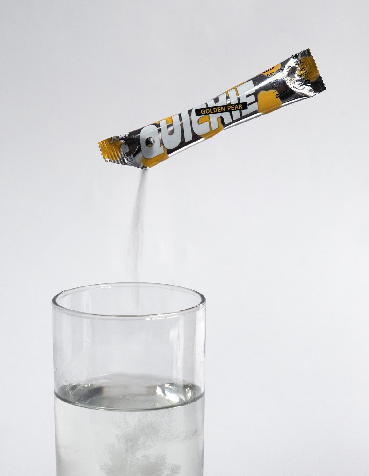 Golden pear quickie being poured into a glass of water.