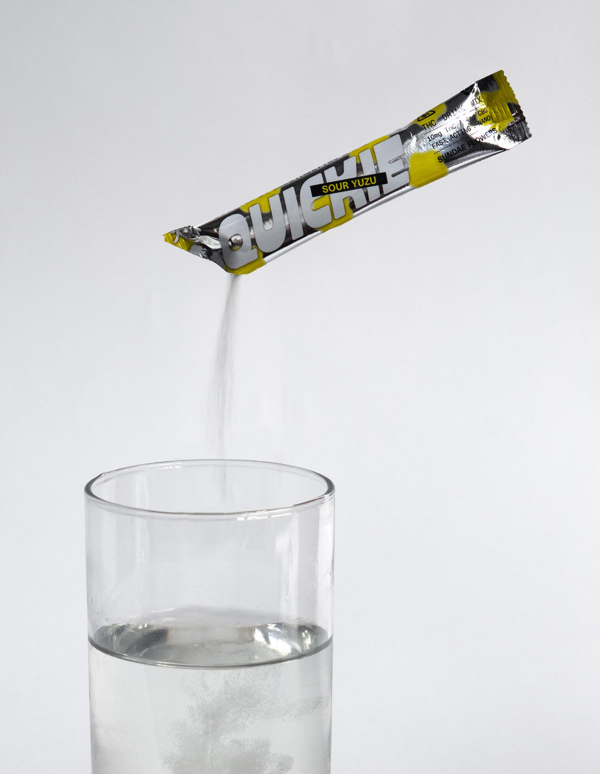 Sour yuzu quickie being poured into a glass of water.