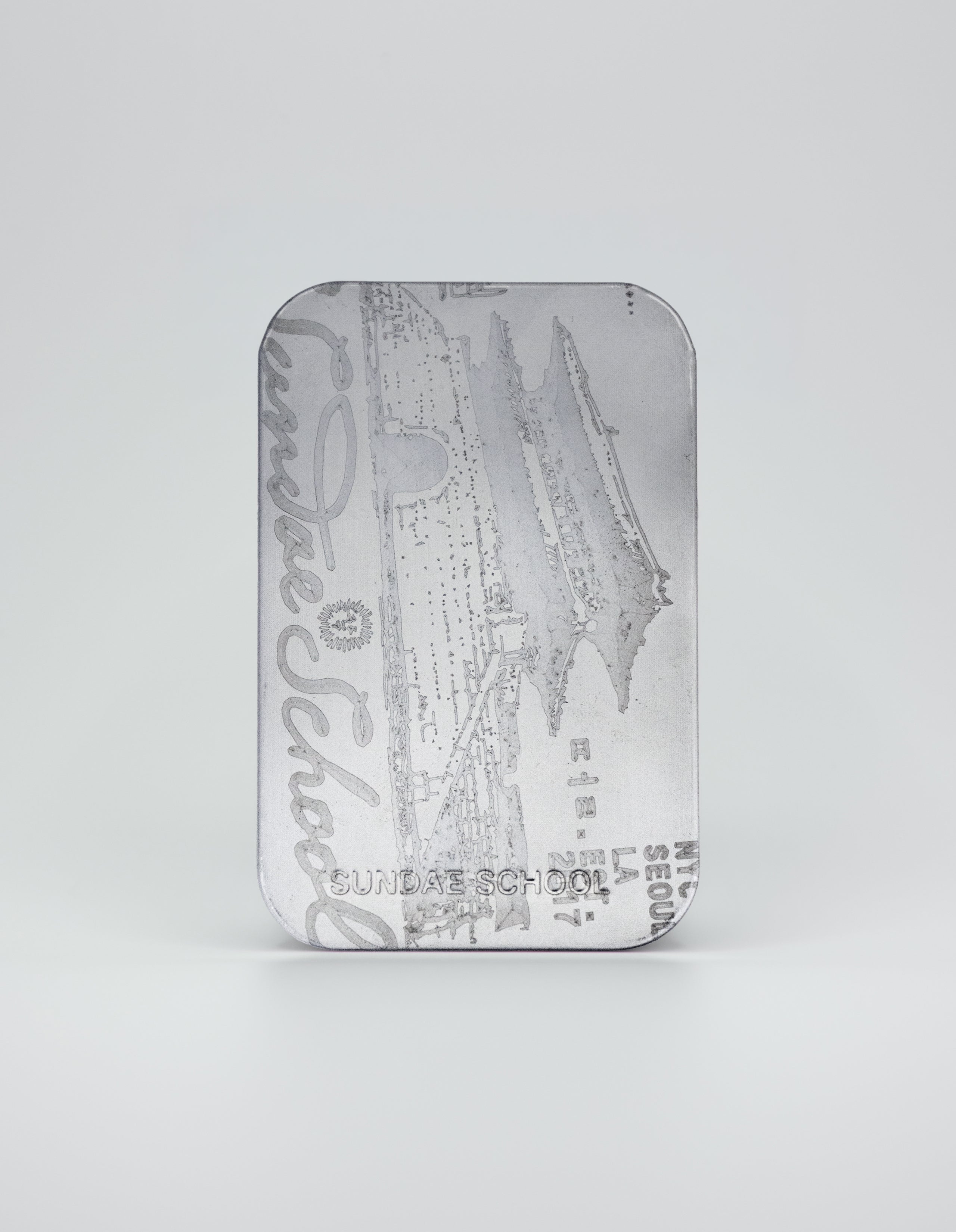 A vertical silver metallic tin featuring a detailed etching of a traditional Korean palace gate. The design includes 